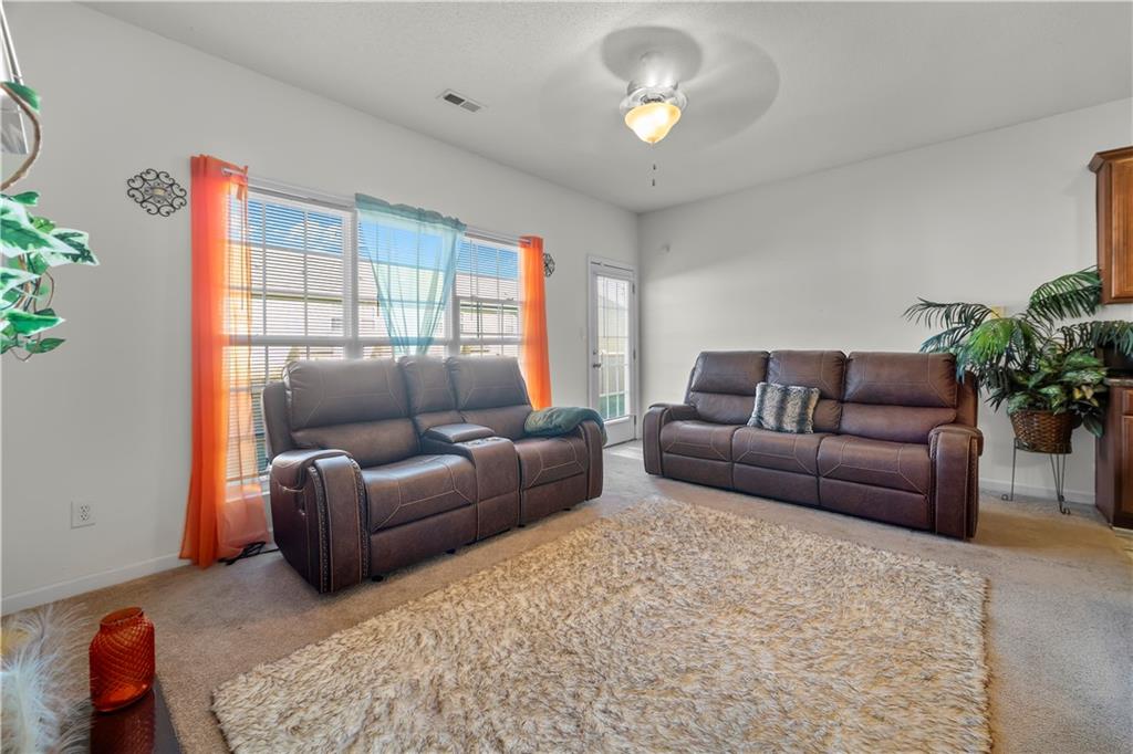 6120 Capitol Knoll Fairburn, GA 30213 - Photo 12 of 28 a living room with furniture and a large window