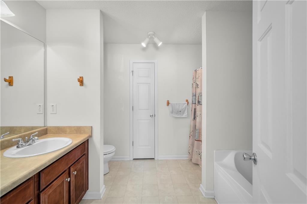 6120 Capitol Knoll Fairburn, GA 30213 - Photo 19 of 28 a bathroom with a tub sink toilet and shower
