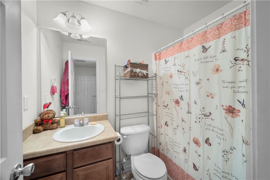6120 Capitol Knoll Fairburn, GA 30213 - Photo 20 of 28 a bathroom with a sink vanity mirror and toilet