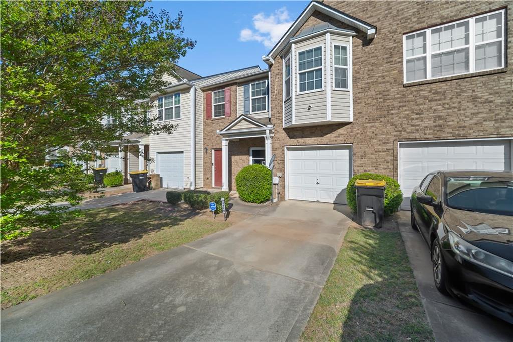 6120 Capitol Knoll Fairburn, GA 30213 - Photo 2 of 28 a front view of a house with a yard and garage