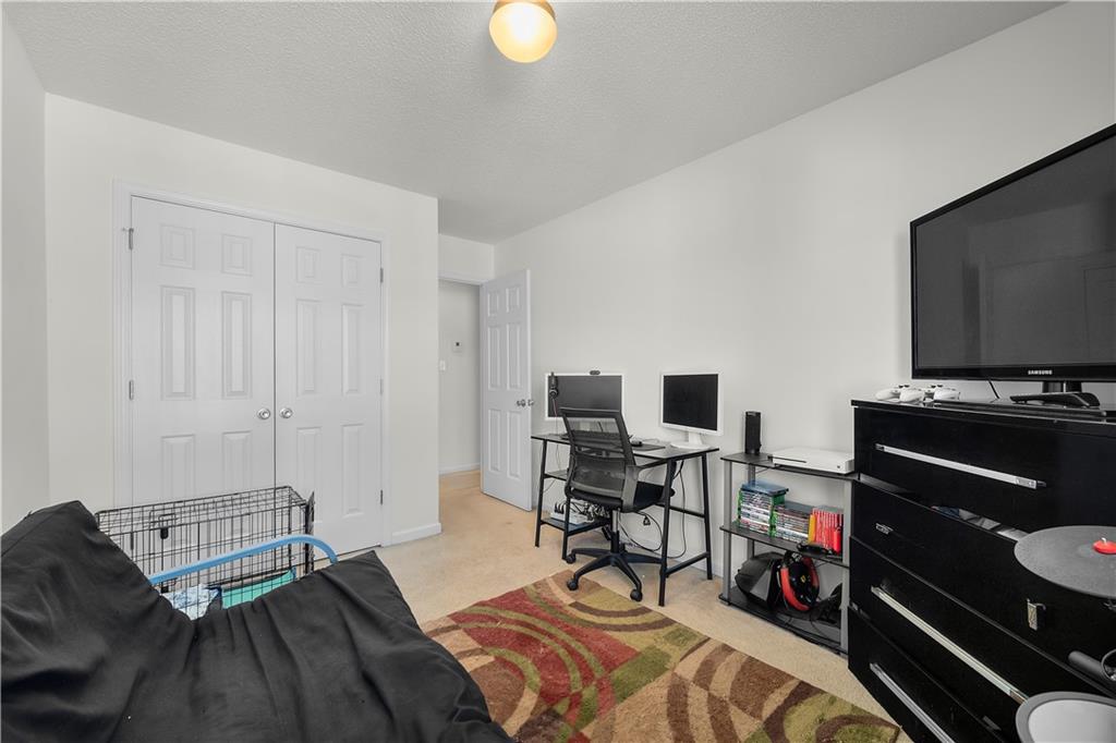 6120 Capitol Knoll Fairburn, GA 30213 - Photo 24 of 28 a bedroom with a bed and a flat screen tv