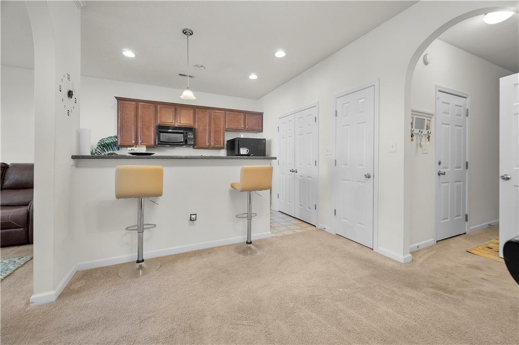 6120 Capitol Knoll Fairburn, GA 30213 - Photo 6 of 28 a kitchen with stainless steel appliances granite countertop a refrigerator sink and cabinets