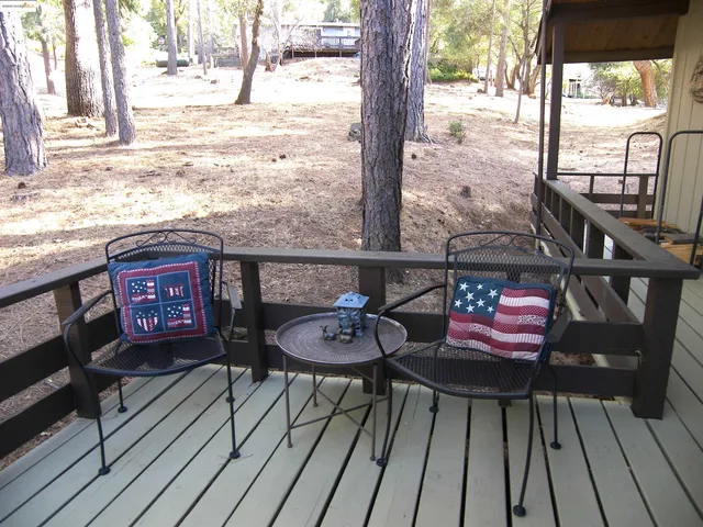 a view of balcony with wooden floor and outdoor seating