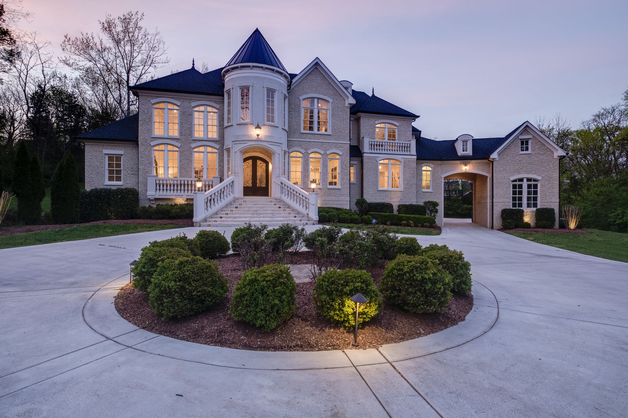 a front view of a house with a yard and outdoor seating