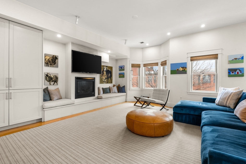 138 West 3rd Street Boston, MA 02127 - Photo 5 of 21 a living room with furniture a flat screen tv and a fireplace