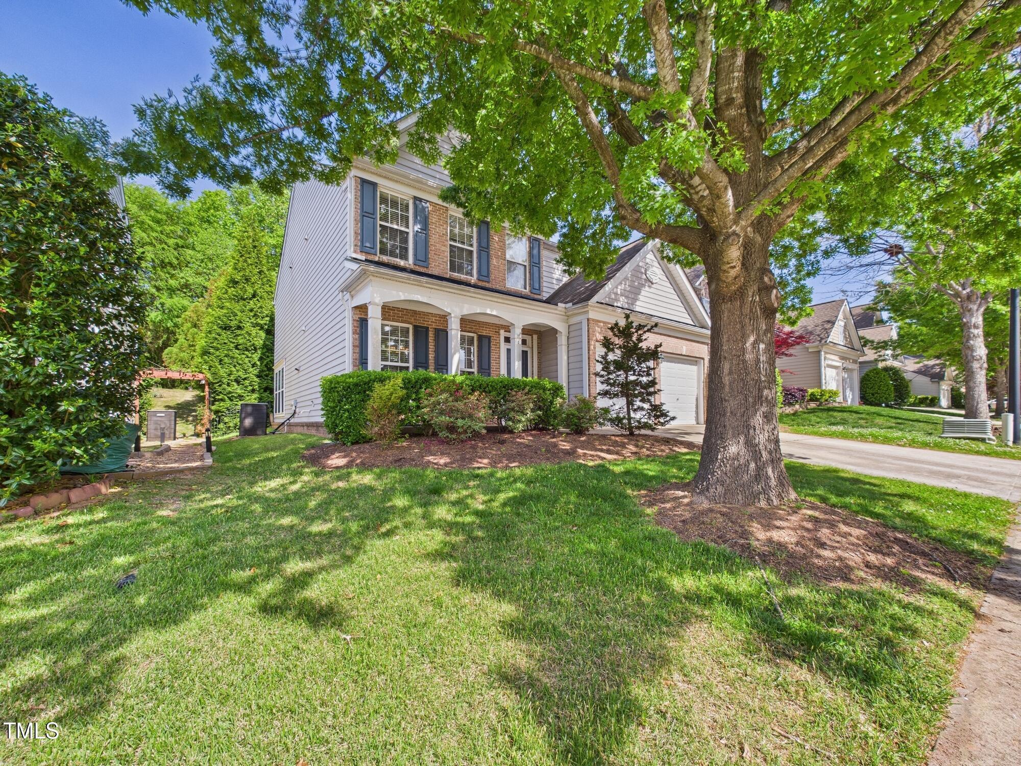 12589 Honeychurch Street Raleigh, NC 27614 - Photo 2 of 100 a front view of a house with garden