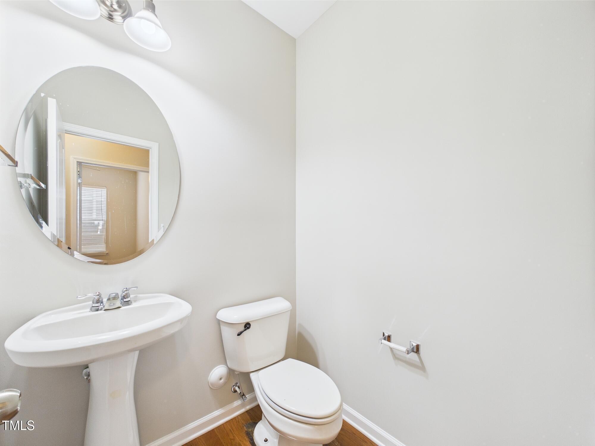 12589 Honeychurch Street Raleigh, NC 27614 - Photo 23 of 100 a bathroom with a toilet a sink and mirror