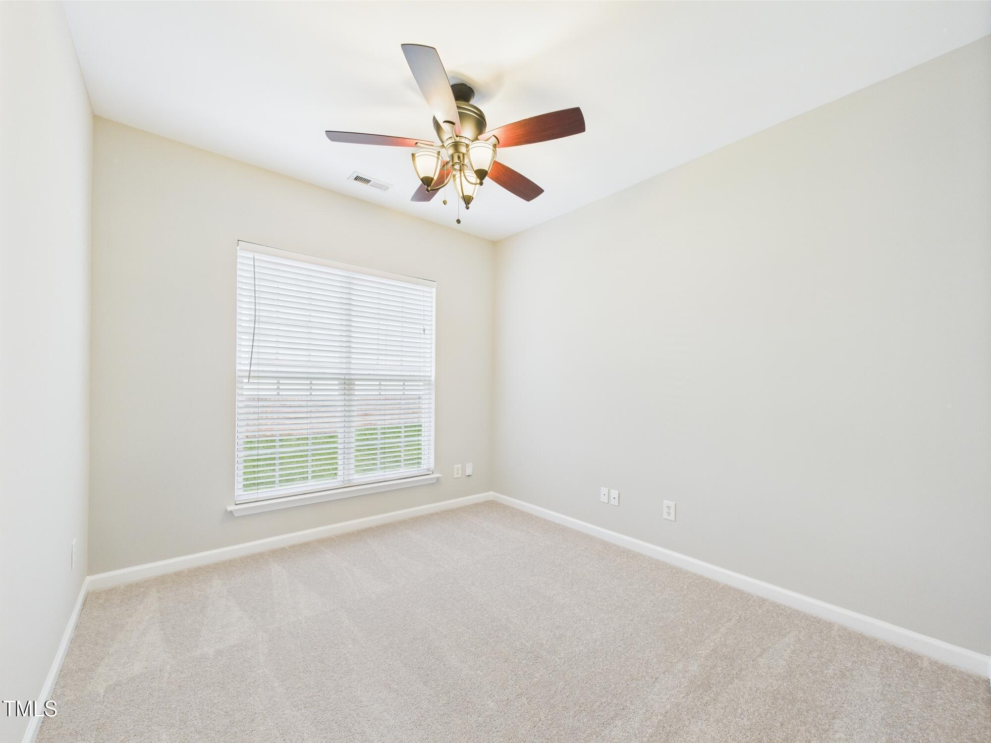 12589 Honeychurch Street Raleigh, NC 27614 - Photo 26 of 100 an empty room with windows and fan
