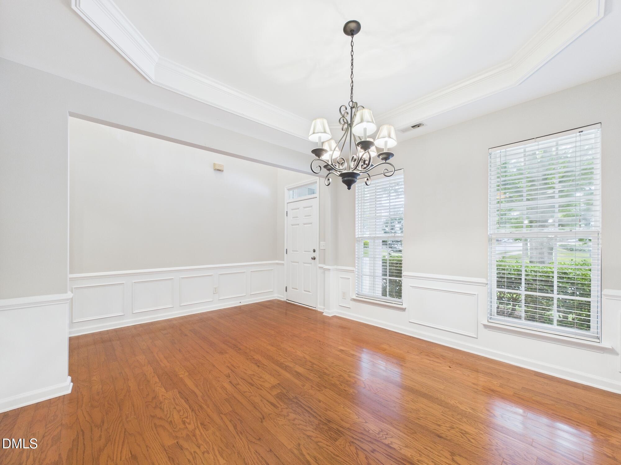 12589 Honeychurch Street Raleigh, NC 27614 - Photo 67 of 100 a view of an empty room with a window and wooden floor