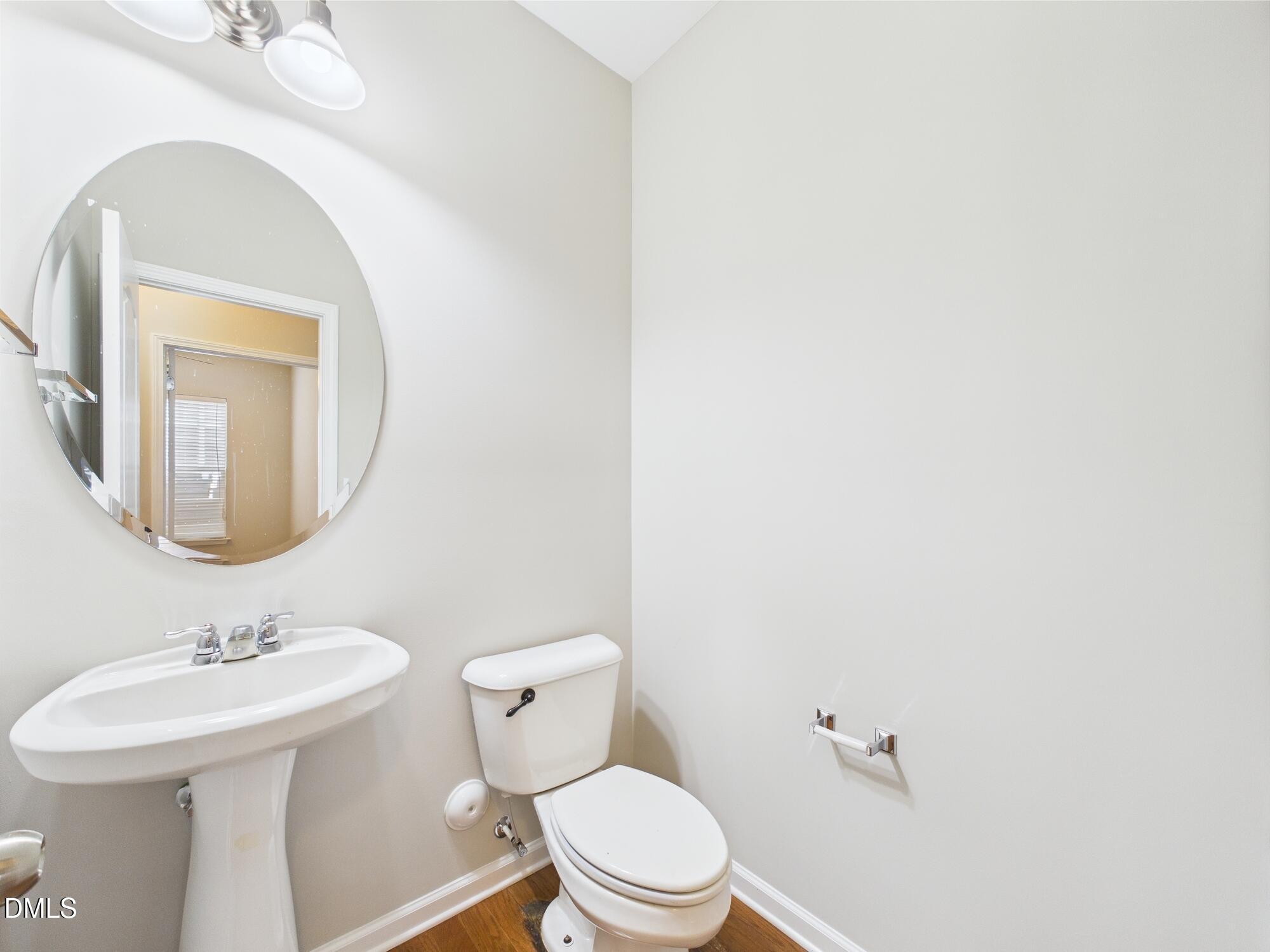 12589 Honeychurch Street Raleigh, NC 27614 - Photo 76 of 100 a bathroom with a toilet a sink and mirror