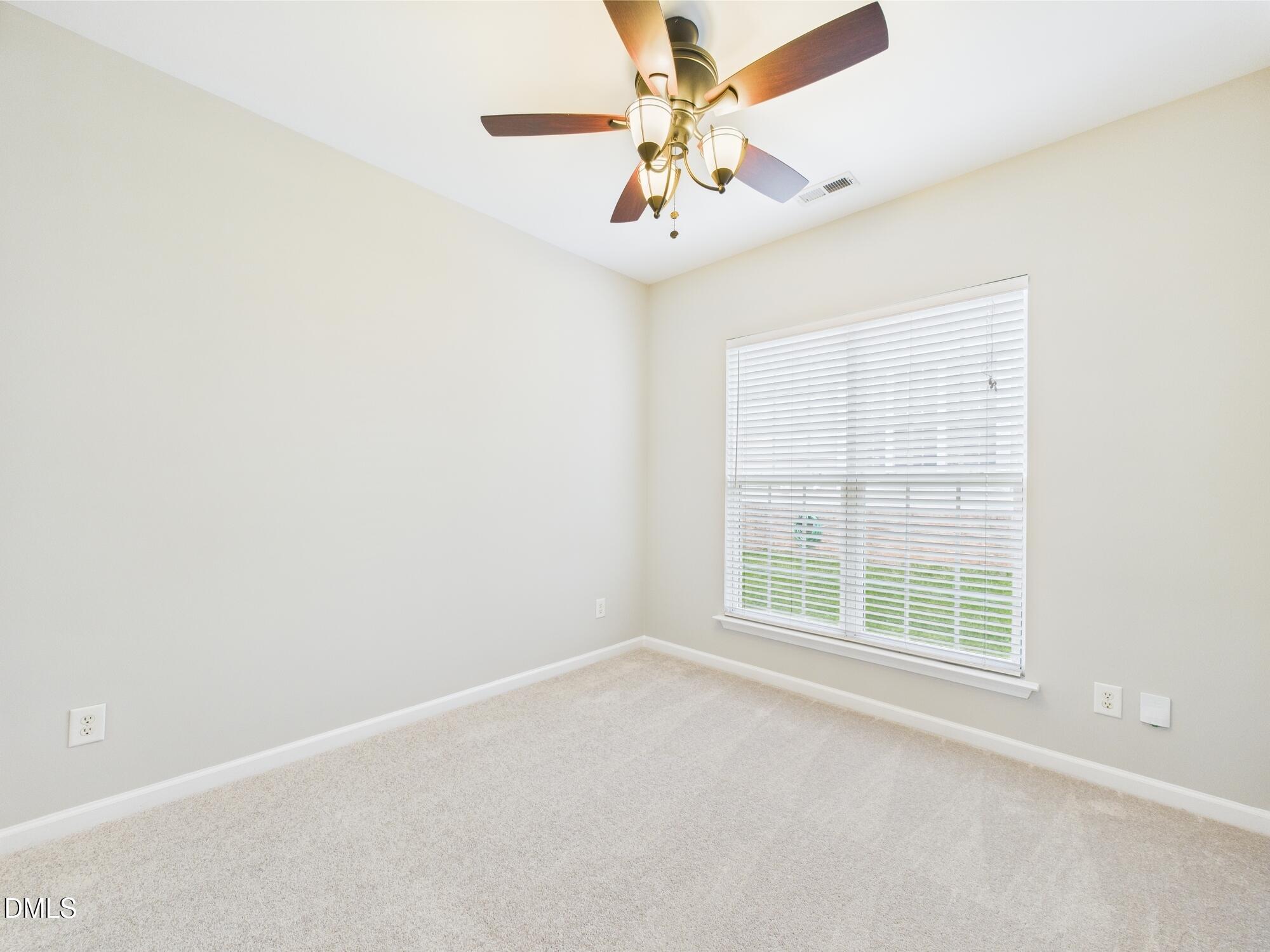 12589 Honeychurch Street Raleigh, NC 27614 - Photo 80 of 100 an empty room with a window and a fan