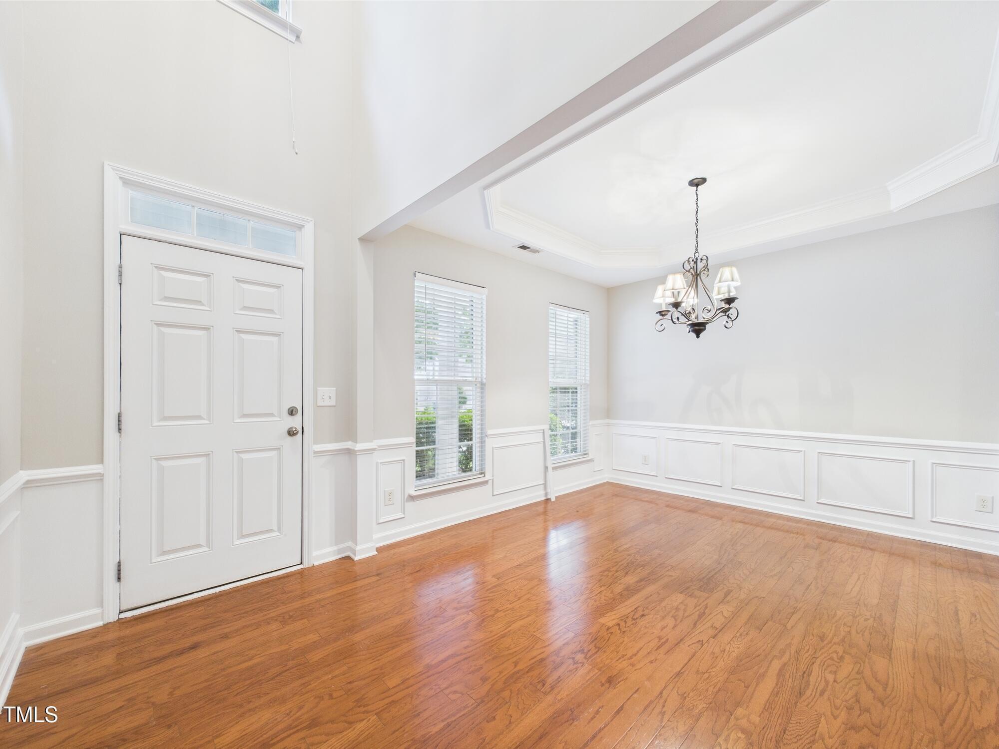 12589 Honeychurch Street Raleigh, NC 27614 - Photo 9 of 100 wooden floor in an empty room with a window