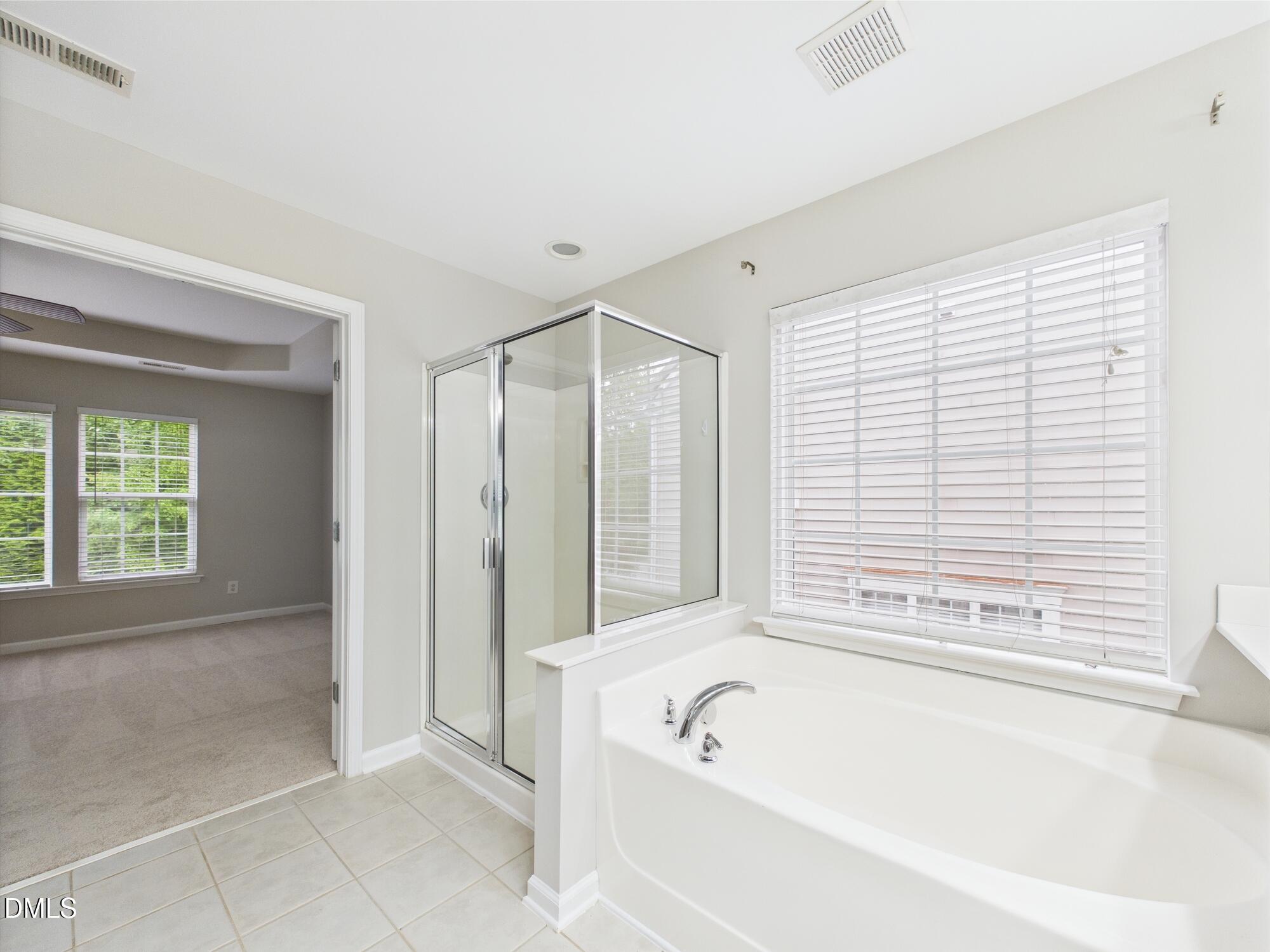 12589 Honeychurch Street Raleigh, NC 27614 - Photo 92 of 100 a bathroom with a bathtub and shower