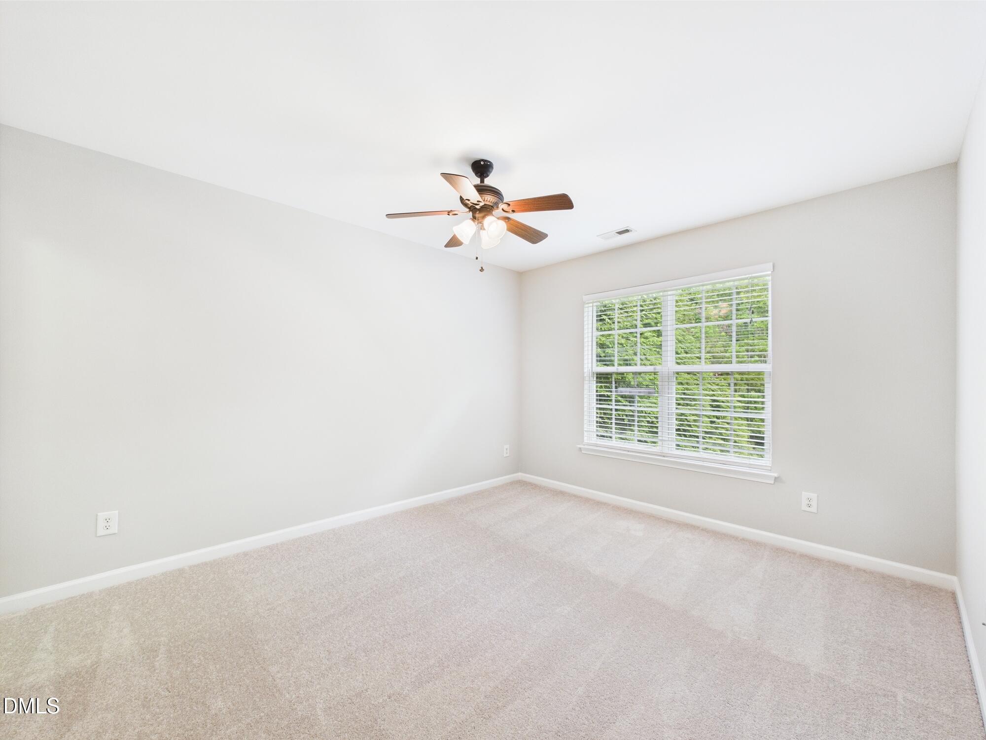 12589 Honeychurch Street Raleigh, NC 27614 - Photo 94 of 100 an empty room with a window and a ceiling fan