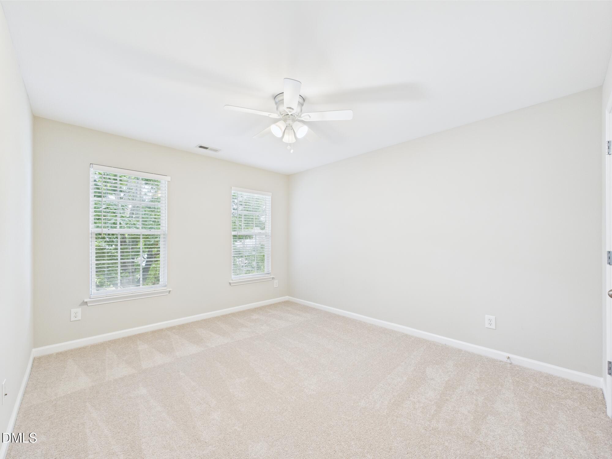 12589 Honeychurch Street Raleigh, NC 27614 - Photo 100 of 100 an empty room with a window and a fan