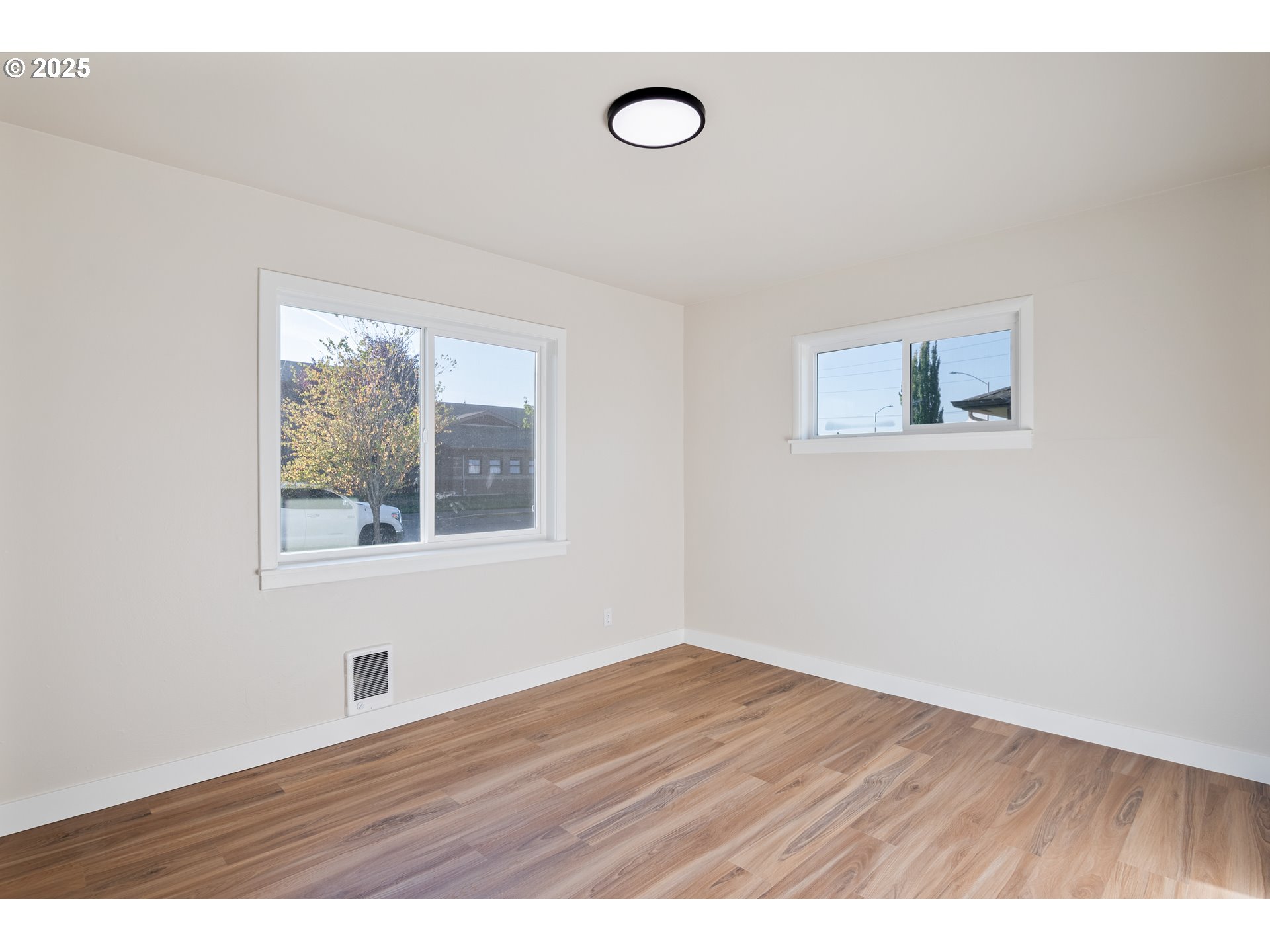435 28th Avenue Longview, WA 98632 - Photo 13 of 24 a view of an empty room with wooden floor and a window
