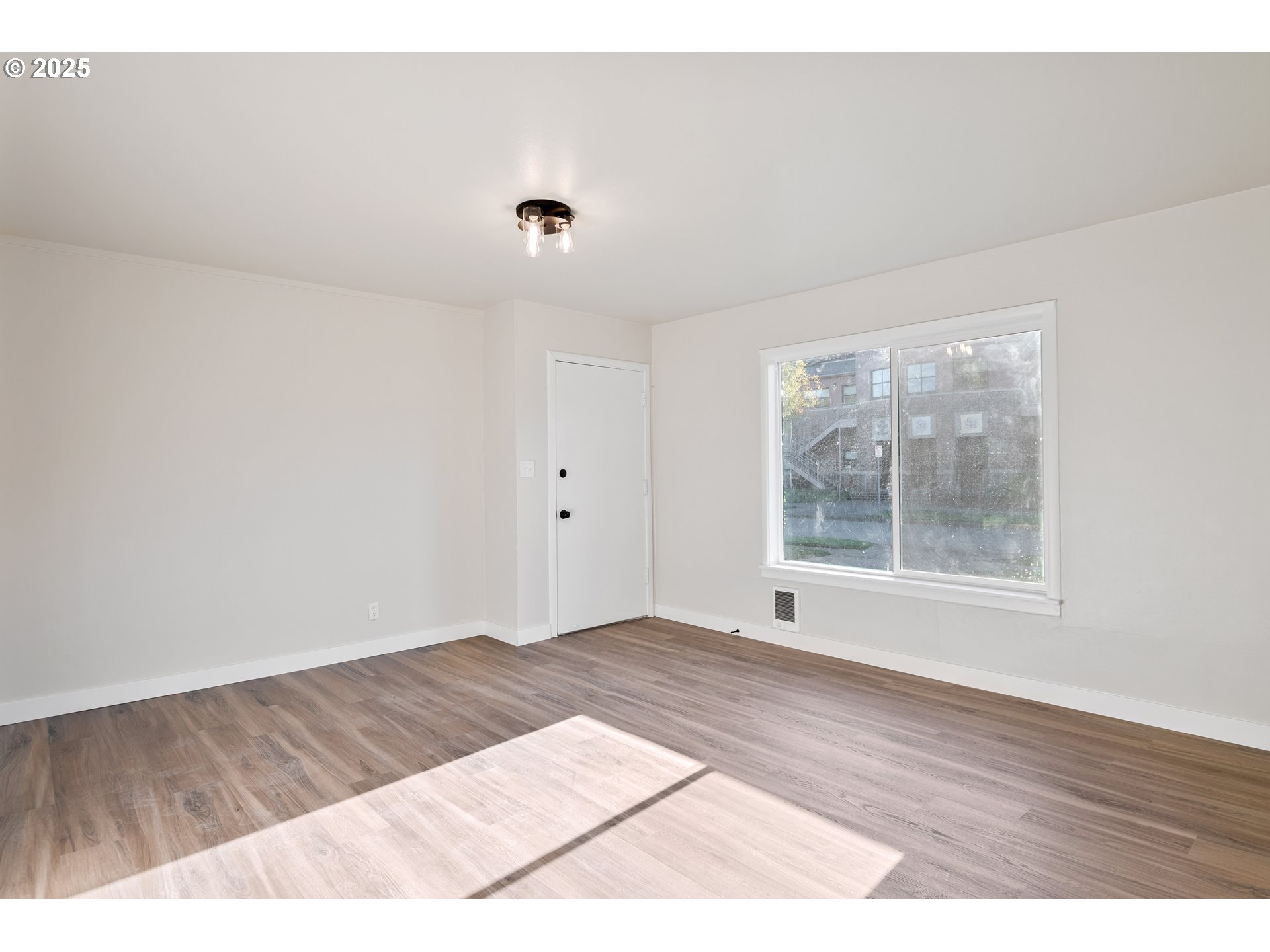 435 28th Avenue Longview, WA 98632 - Photo 5 of 24 a view of an empty room with wooden floor and a window