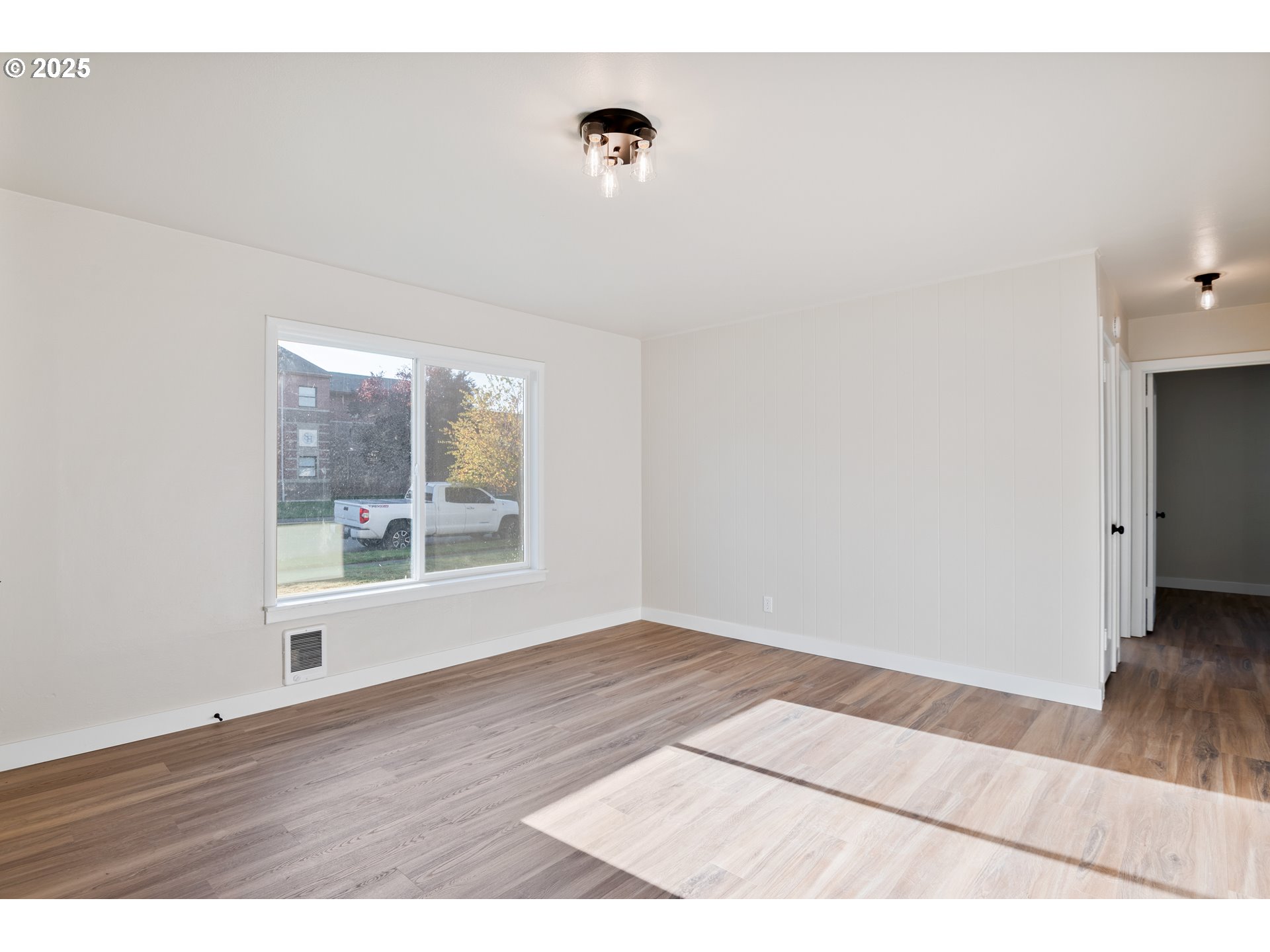 435 28th Avenue Longview, WA 98632 - Photo 6 of 24 a view of an empty room with wooden floor and a window