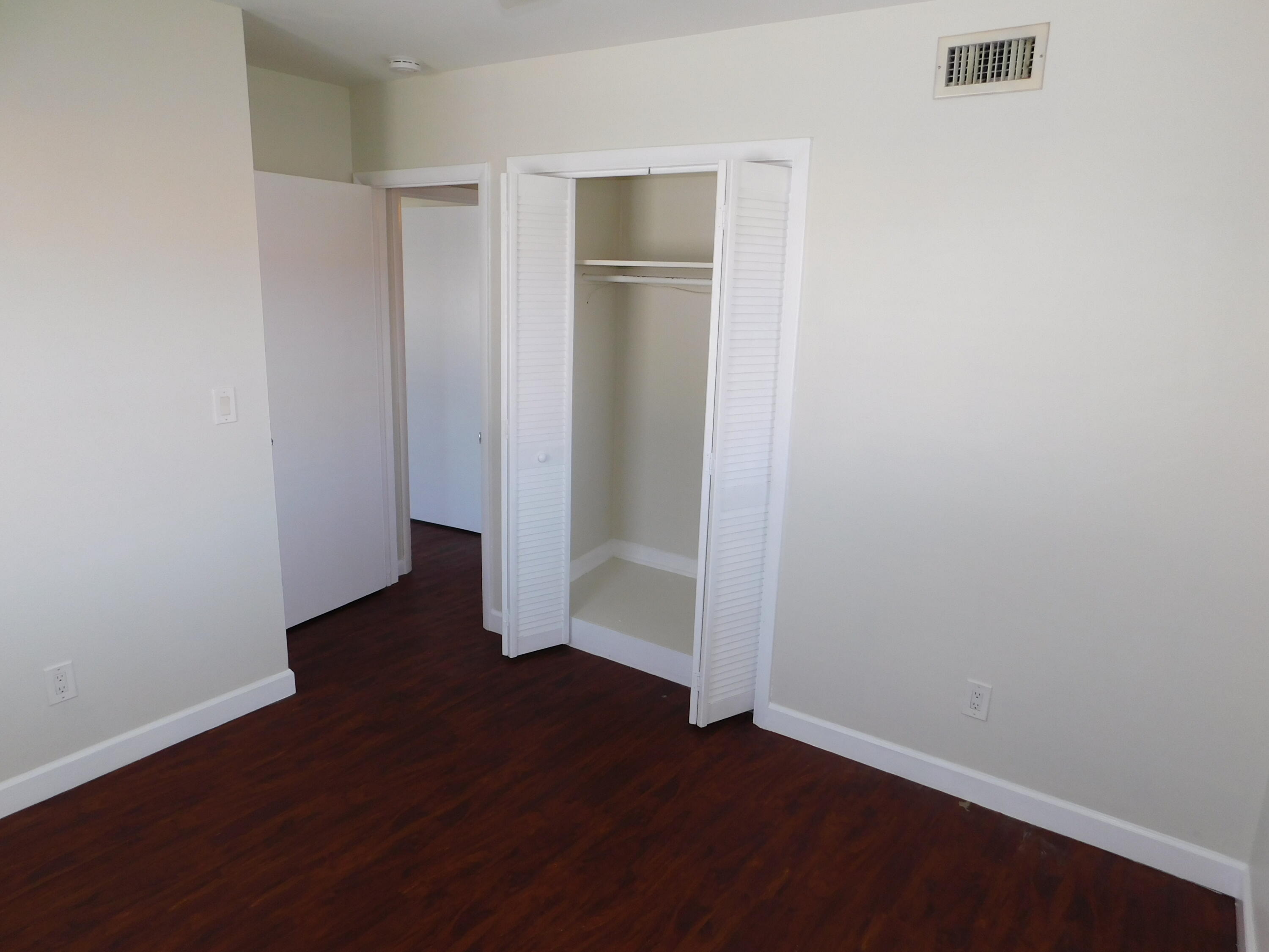 741 Hummingbird Way, Unit 4 North Palm Beach, FL 33408 - Photo 10 of 19 an empty room with wooden floor and closet
