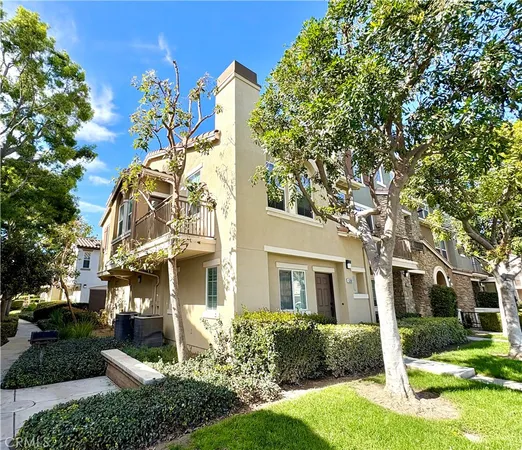 a view of a white house with a yard and plants