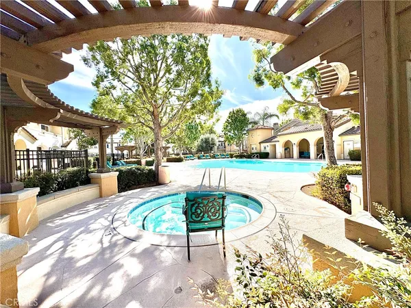 a swimming pool with outdoor seating and yard