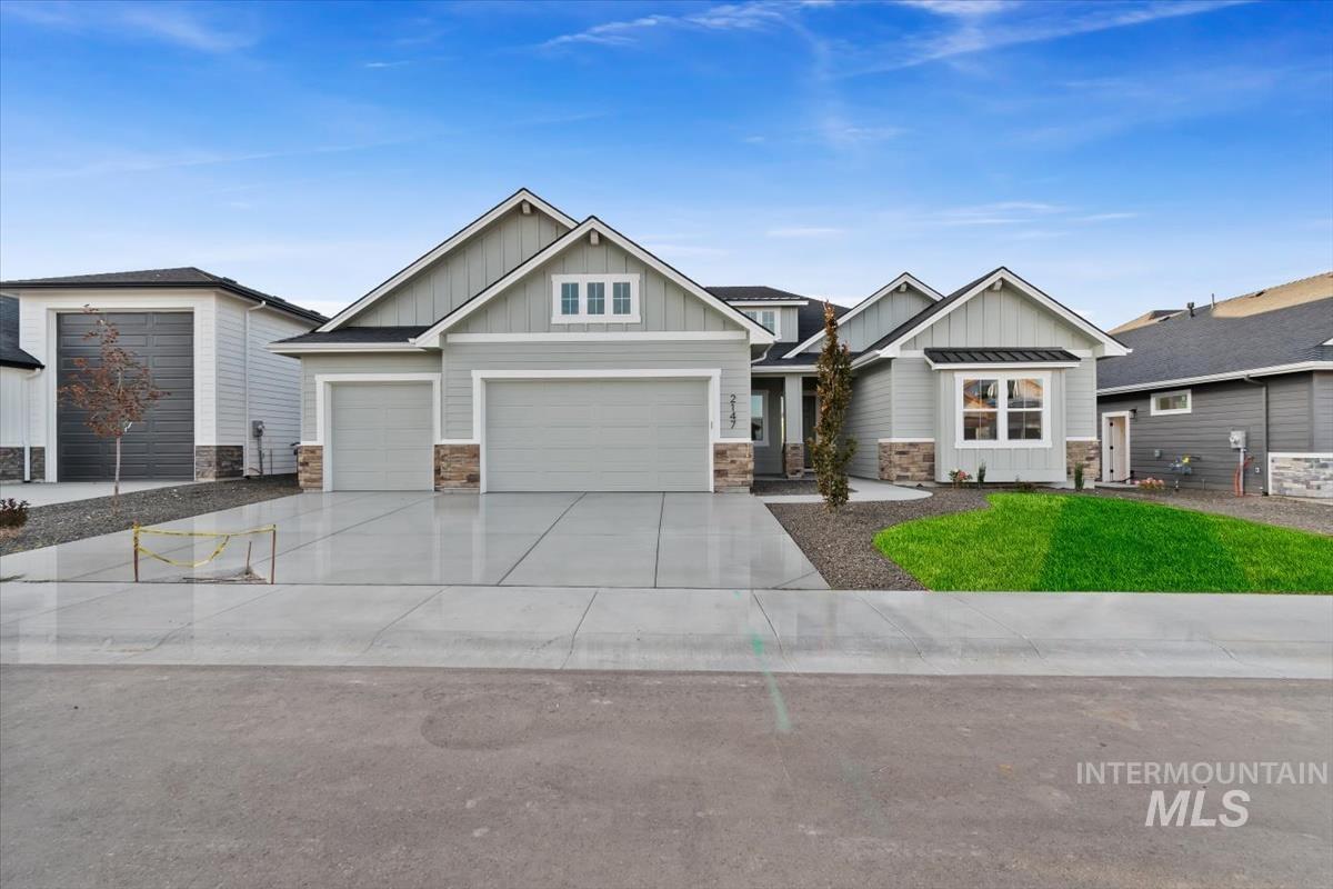 2147 East Blakehurst Avenue Kuna, ID 83634 - Photo 1 of 43 Craftsman-style house featuring board and batten siding, stone siding, and concrete driveway