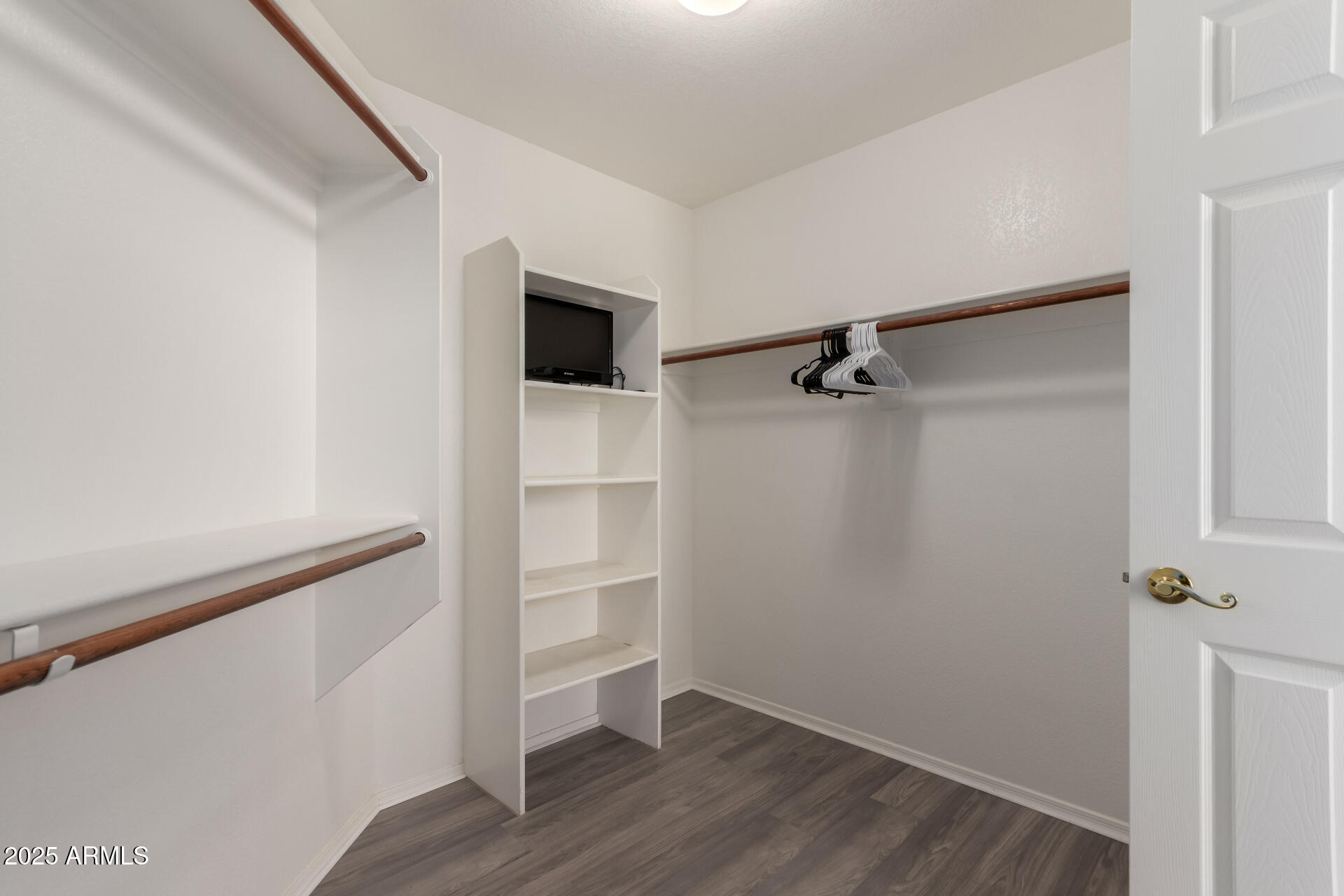 1182 East Harrison Street Gilbert, AZ 85295 - Photo 15 of 23 a view of walk in closet with empty racks