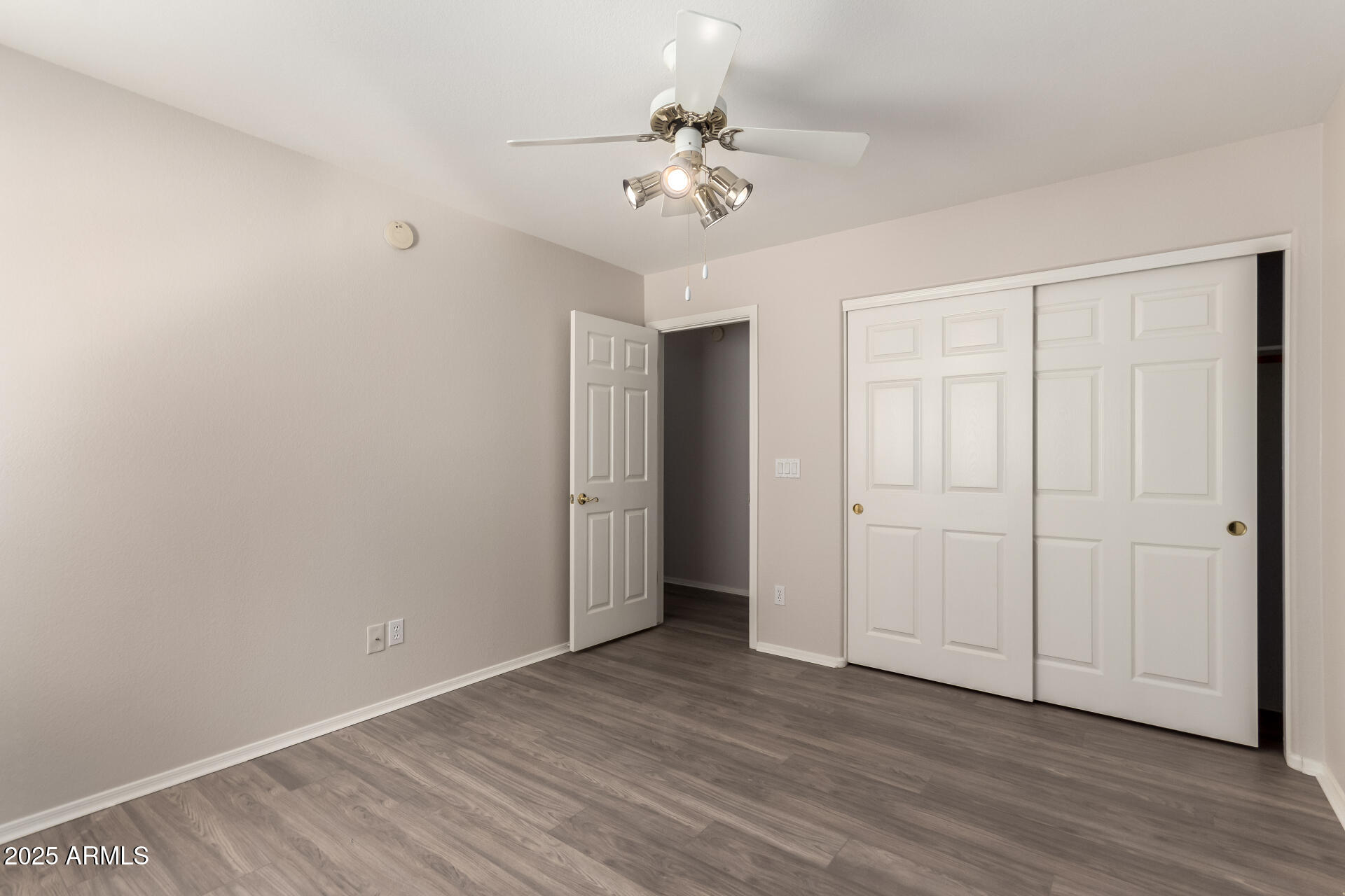 1182 East Harrison Street Gilbert, AZ 85295 - Photo 16 of 21 a view of a room with wooden floor and a ceiling fan