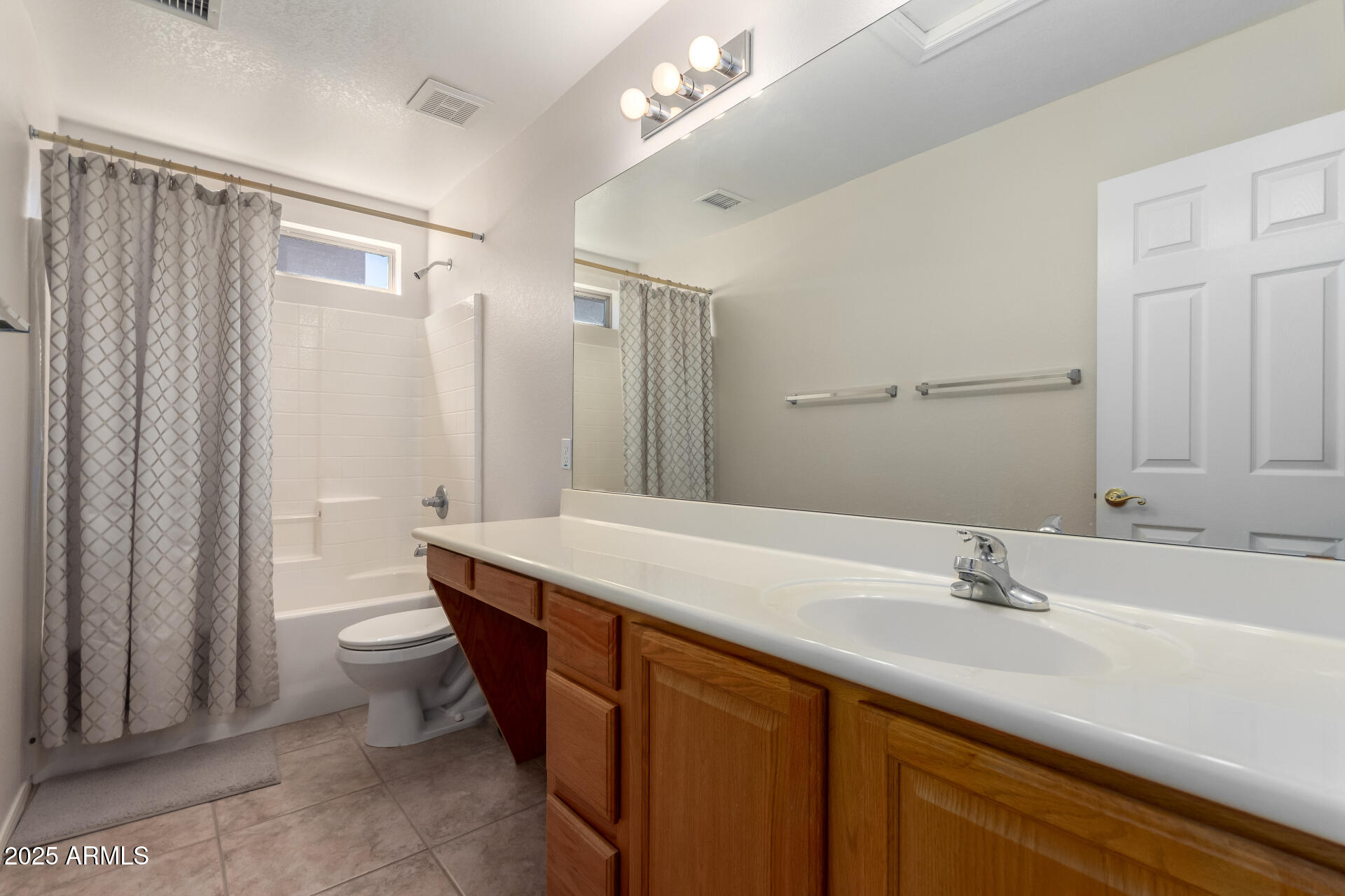 1182 East Harrison Street Gilbert, AZ 85295 - Photo 17 of 21 a bathroom with a sink a toilet a mirror and shower