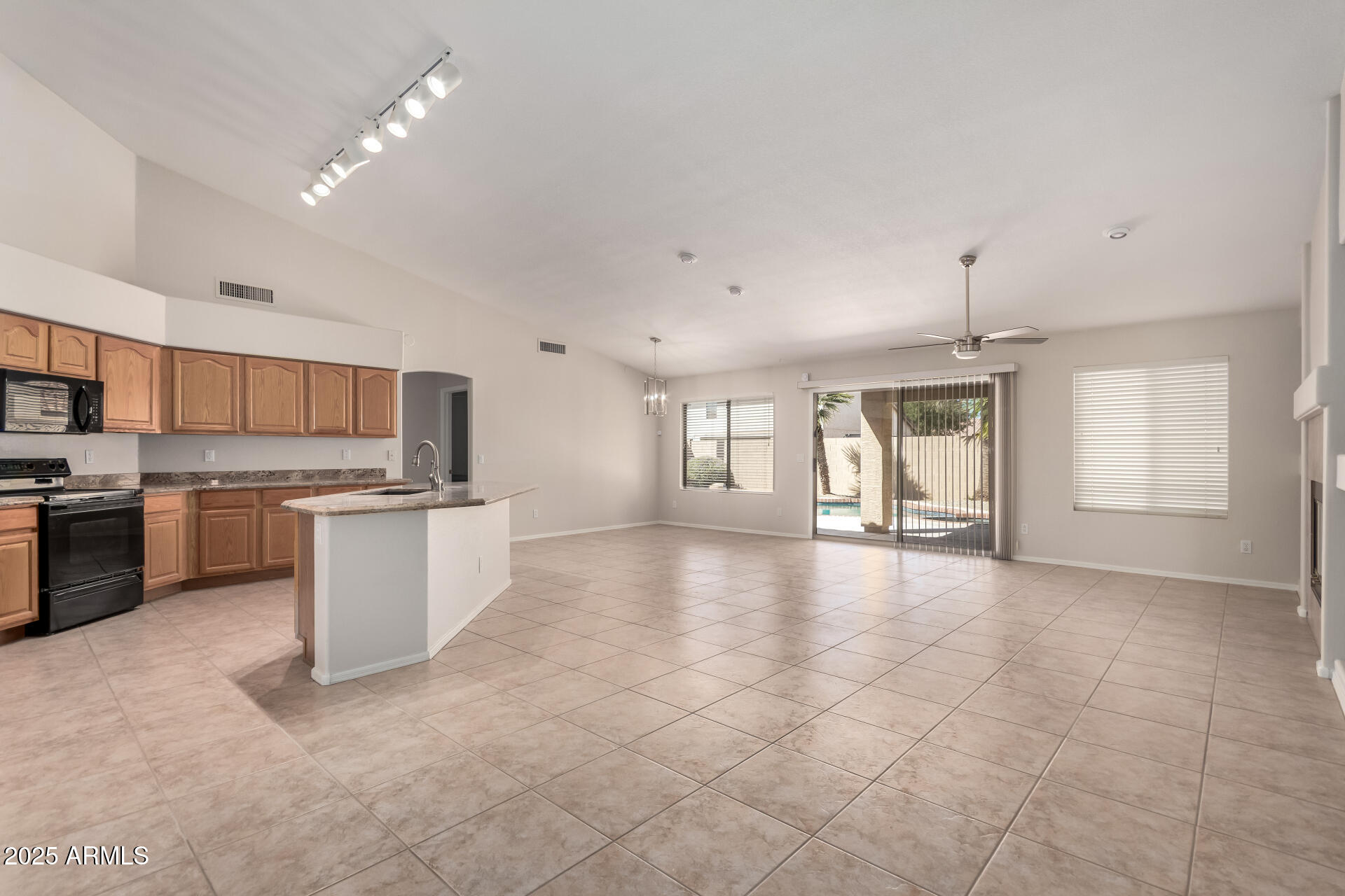 1182 East Harrison Street Gilbert, AZ 85295 - Photo 5 of 23 a open kitchen with cabinets and stainless steel appliances