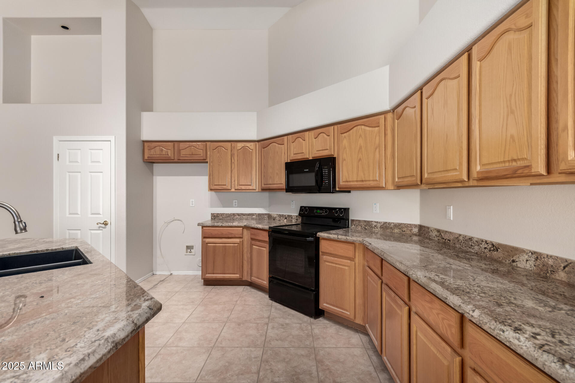 1182 East Harrison Street Gilbert, AZ 85295 - Photo 9 of 23 a kitchen with stainless steel appliances granite countertop a stove top oven a sink dishwasher and a microwave oven with white cabinets