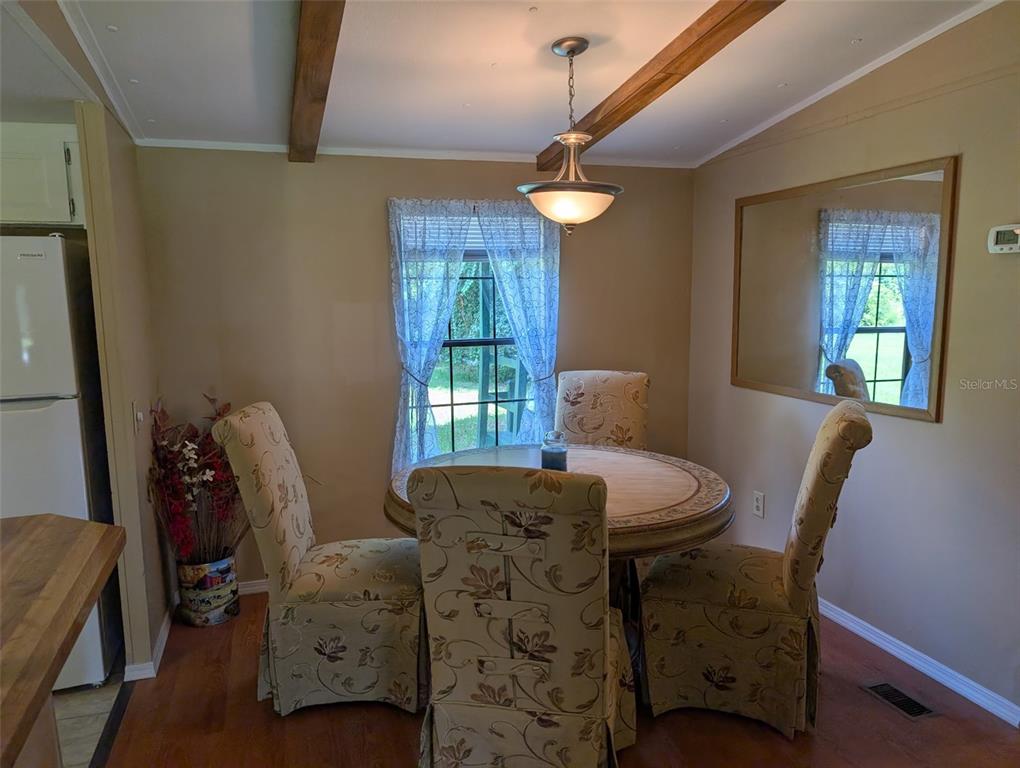 56314 Blue Creek Road Astor, FL 32102 - Photo 13 of 23 a view of a dining room with furniture and window
