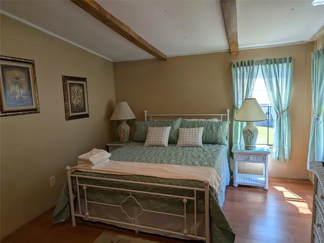 a bedroom with a bed chair and a window