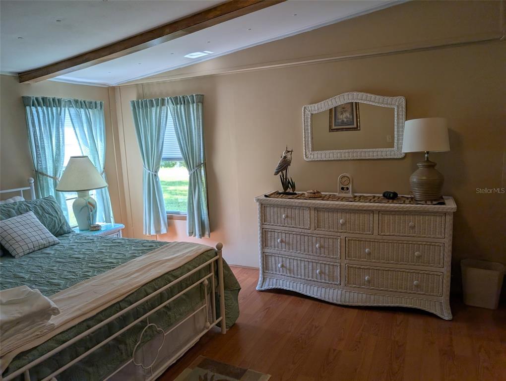 56314 Blue Creek Road Astor, FL 32102 - Photo 18 of 23 a bedroom with a bed and large windows