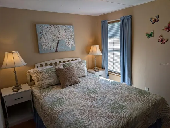 a bedroom with a large bed and a window