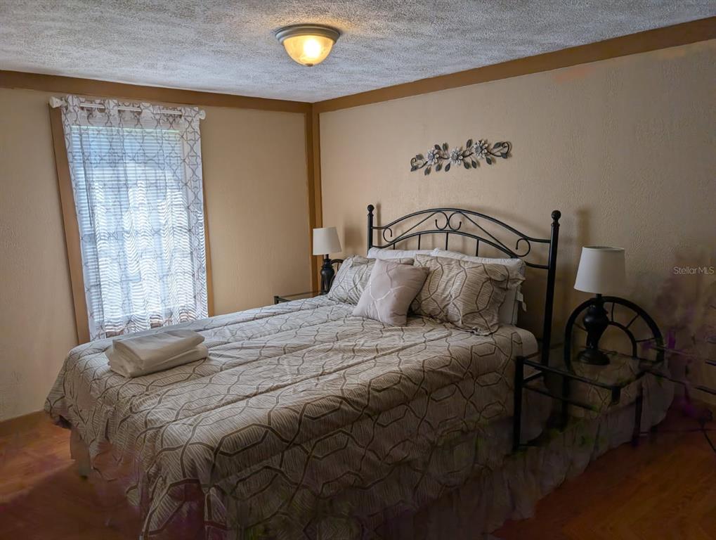 56314 Blue Creek Road Astor, FL 32102 - Photo 20 of 23 a bedroom with a bed and a window