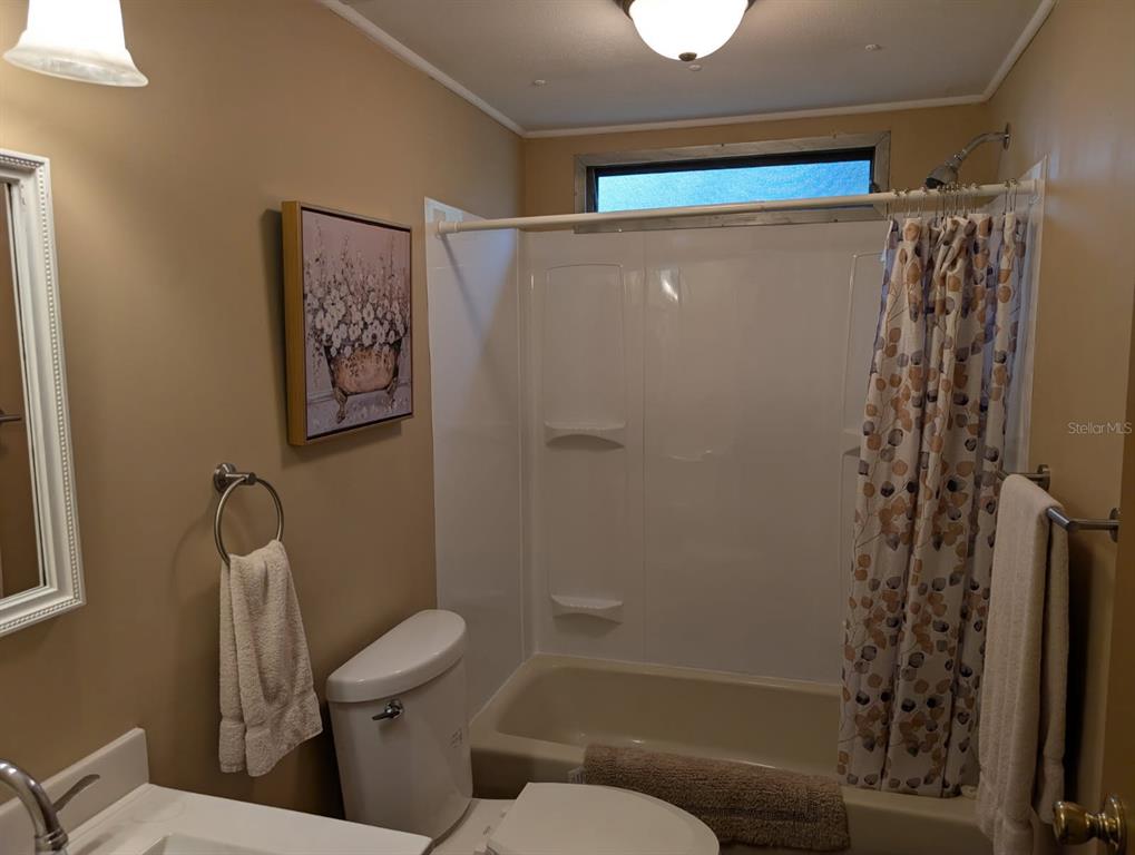 56314 Blue Creek Road Astor, FL 32102 - Photo 22 of 23 a bathroom with a toilet and a shower