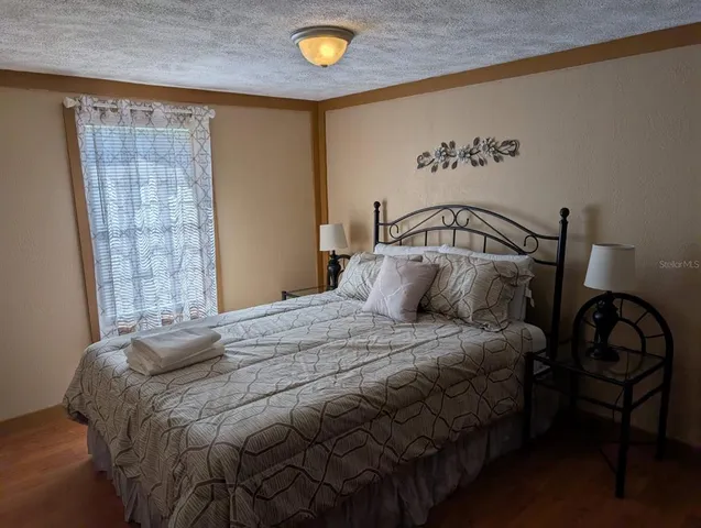 a bedroom with a bed and a window