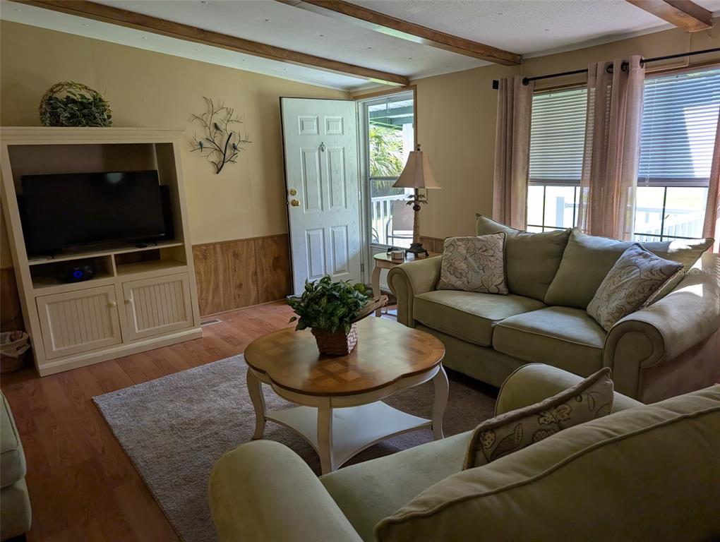 56314 Blue Creek Road Astor, FL 32102 - Photo 9 of 23 a living room with furniture and a flat screen tv
