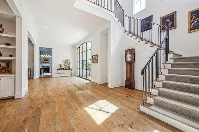 a view of entryway and hall with wooden floor