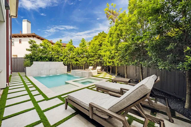 a view of a house with backyard and sitting area