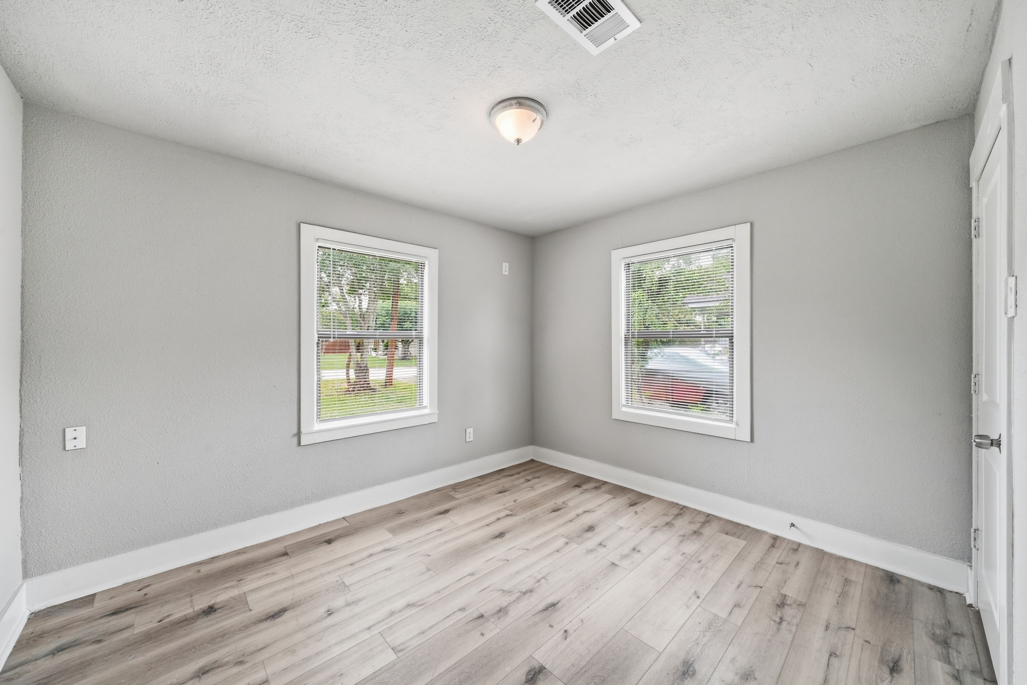 1718 Miami Road Pasadena, TX 77502 - Photo 9 of 11 a view of an empty room with wooden floor and a window