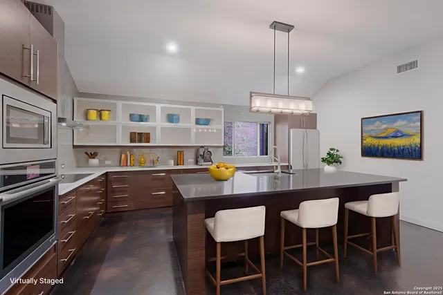 a kitchen with a dining table chairs counter space and cabinets