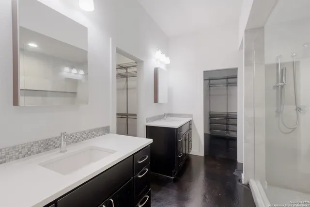 a bathroom with a sink double vanity and a mirror