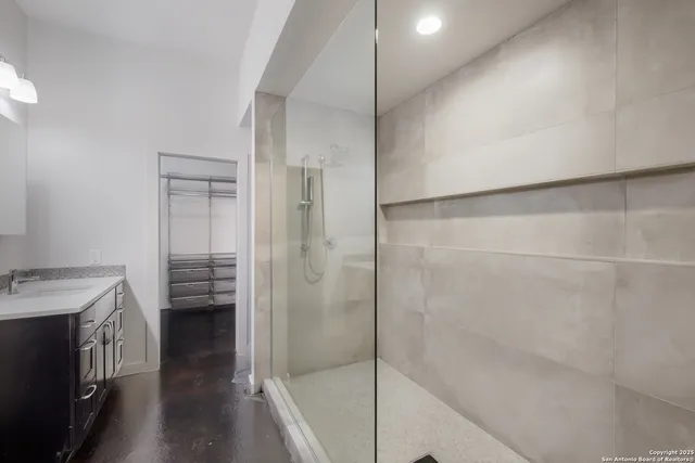 a bathroom with a shower and a sink