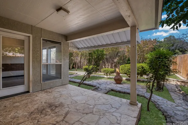 a view of a porch with furniture and garden