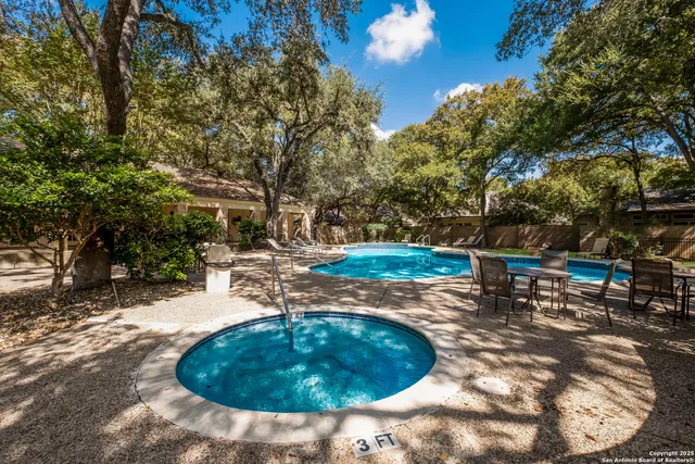 a view of a swimming pool with a sitting area