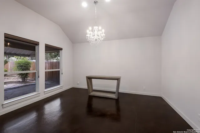 a view of room with window and wooden floor