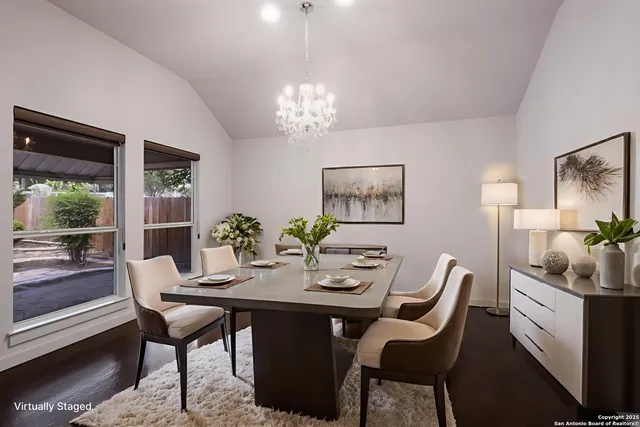 a dining room with furniture a rug and a chandelier