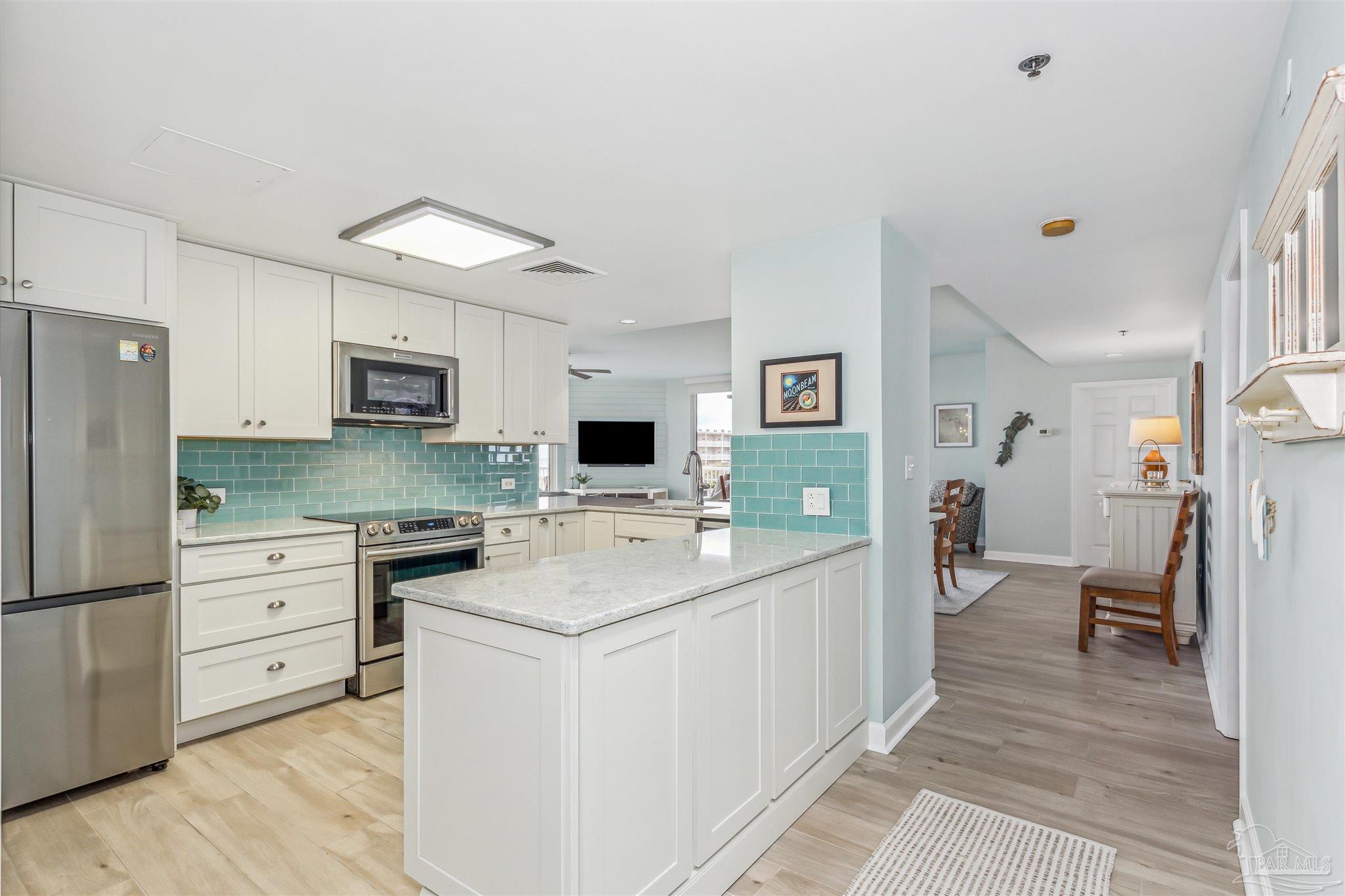 800 Fort Pickens Road, Unit 204 Pensacola Beach, FL 32561 - Photo 19 of 45 a kitchen with a sink appliances and cabinets
